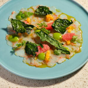 Carpaccio di gamberi, cavolo nero, kaki in carpione, agrumi e zucca
